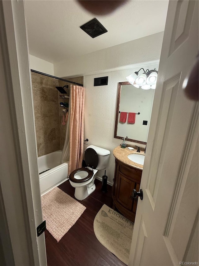 8318 Ivory Loop, Peyton, CO 80831 - bathroom with toilet, a textured wall, vanity, wood finished floors, and shower / tub combo with curtain