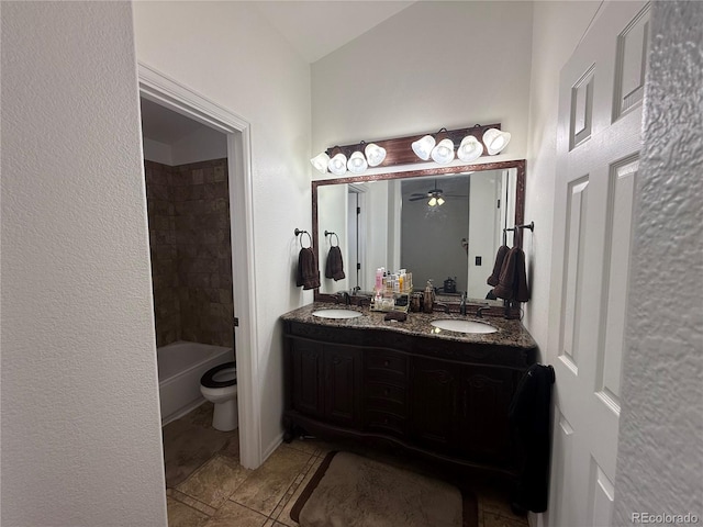 8318 Ivory Loop, Peyton, CO 80831 - bathroom with double vanity, toilet, a ceiling fan, and tile patterned flooring