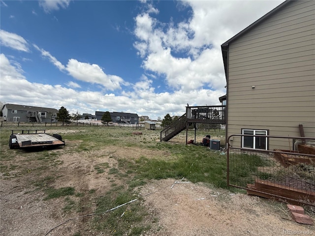 8318 Ivory Loop, Peyton, CO 80831 - view of yard featuring a deck, stairway, fence, and central air condition unit