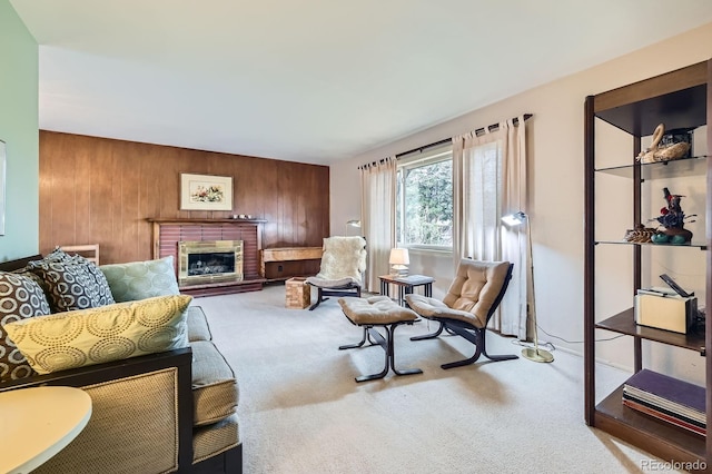 carpeted living area with wooden walls and a fireplace