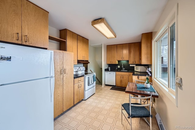 kitchen with white appliances, light floors, open shelves, a sink, and dark countertops