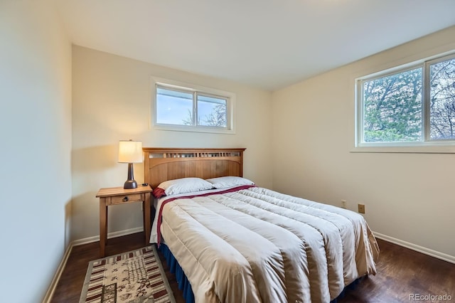 bedroom with wood finished floors and baseboards