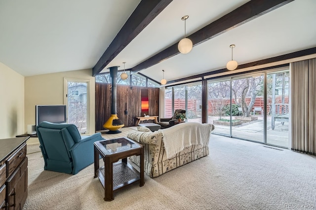 carpeted living room with vaulted ceiling with beams