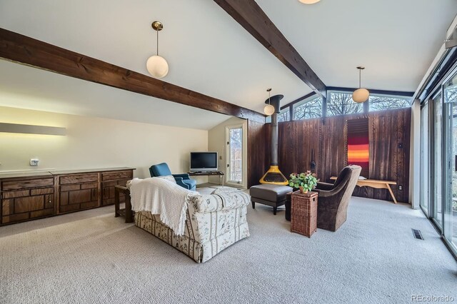 carpeted living room featuring visible vents and lofted ceiling with beams