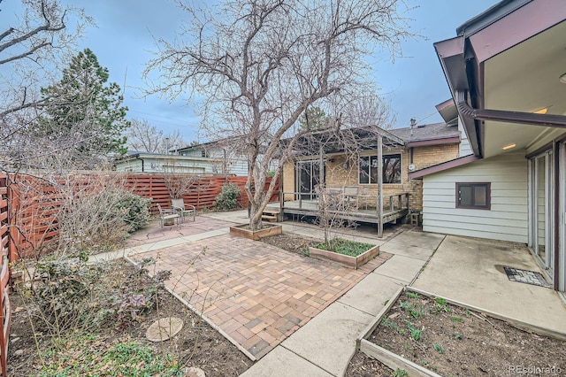 view of yard featuring a garden, a patio, and fence