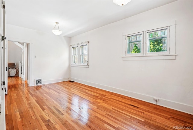 unfurnished room featuring light wood-style flooring and baseboards