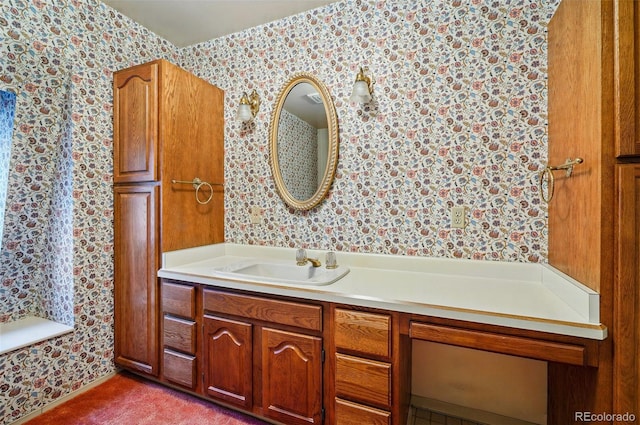 bathroom featuring wallpapered walls and vanity