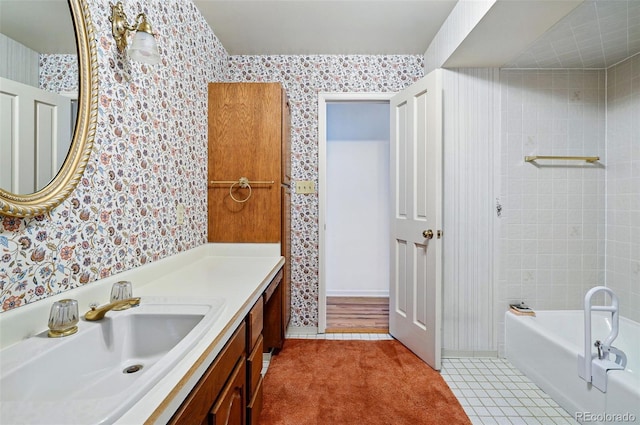 full bath featuring wallpapered walls, a bathtub, and vanity