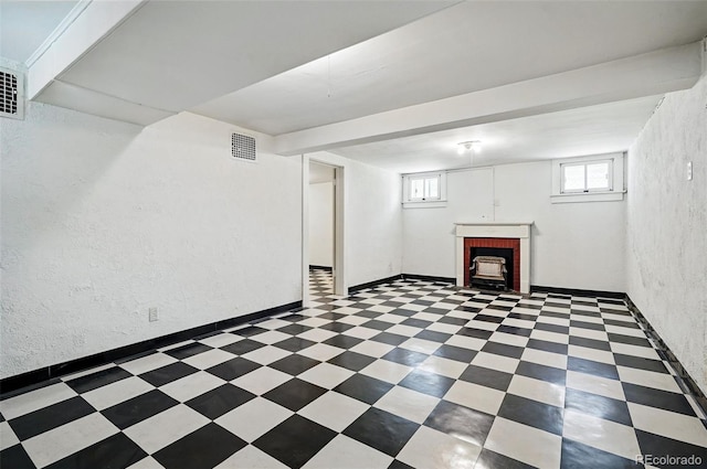 below grade area featuring a textured wall and tile patterned floors