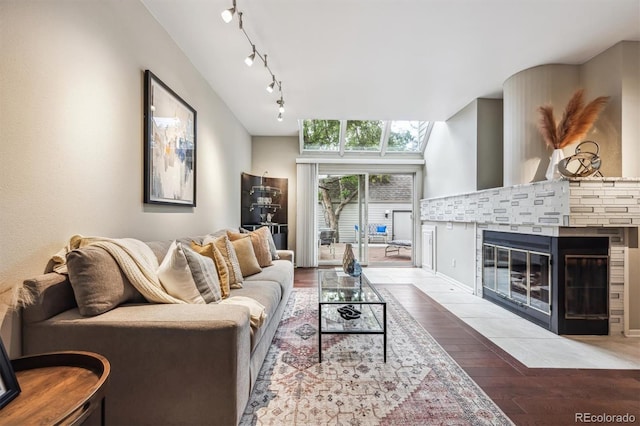 345 Harrison St, Denver, CO 80206 - living room with wood finished floors, a tile fireplace, and track lighting