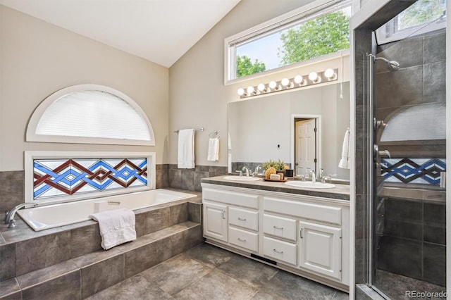345 Harrison St, Denver, CO 80206 - bathroom with double vanity, tiled shower, a garden tub, and high vaulted ceiling