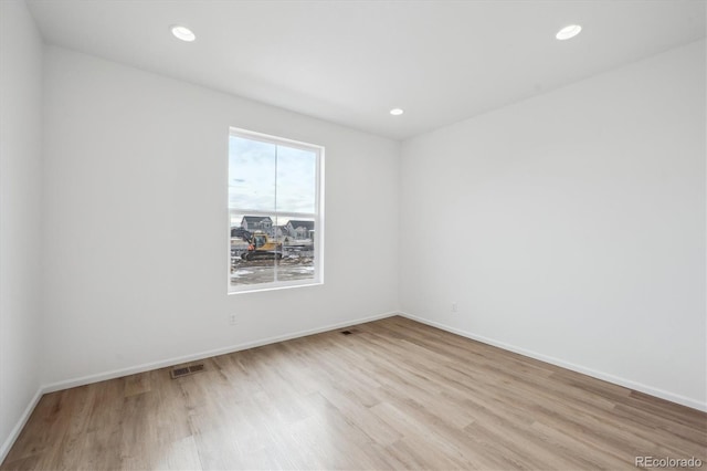 unfurnished room with light wood-type flooring