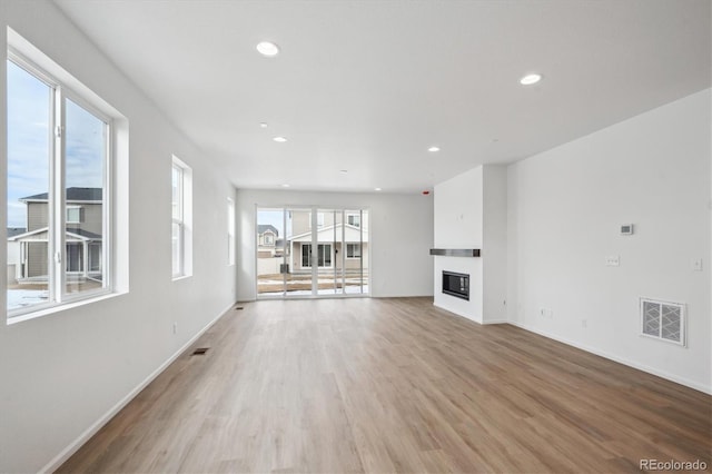 unfurnished living room featuring light hardwood / wood-style floors