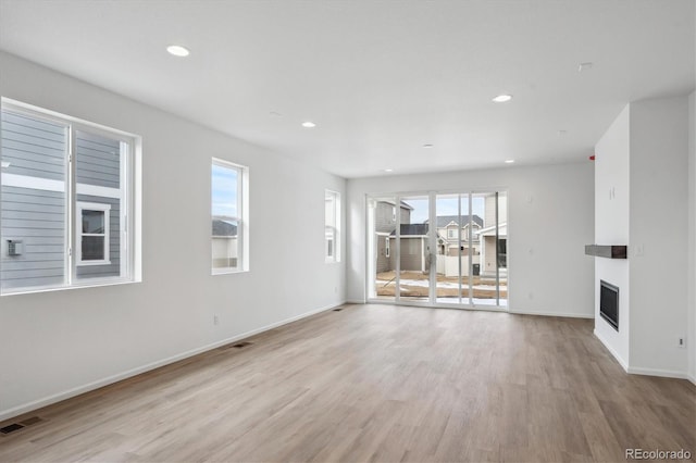 unfurnished living room featuring light hardwood / wood-style flooring