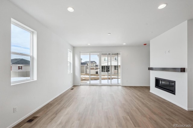 unfurnished living room with light hardwood / wood-style flooring