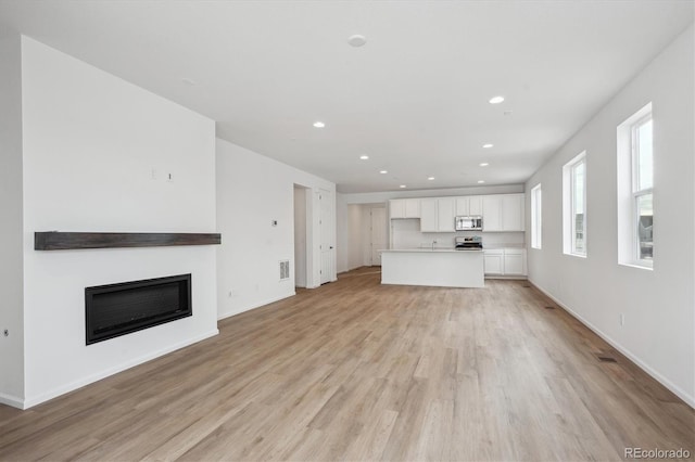 unfurnished living room with light hardwood / wood-style flooring