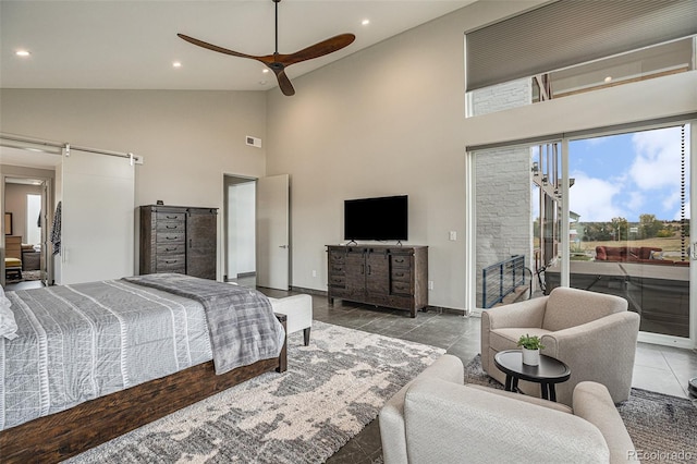 tiled bedroom with access to exterior, a barn door, high vaulted ceiling, and ceiling fan