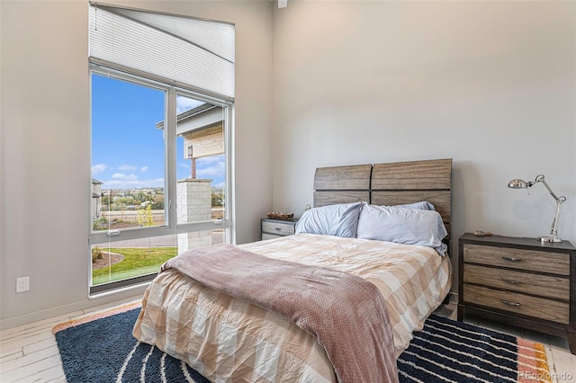 bedroom featuring multiple windows and light hardwood / wood-style floors