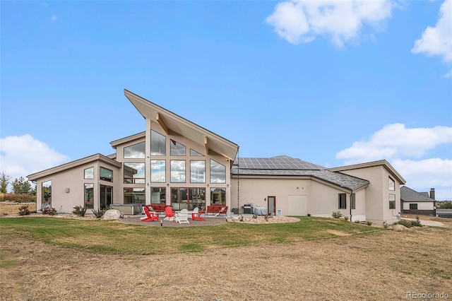 back of house featuring solar panels, a yard, and a patio area