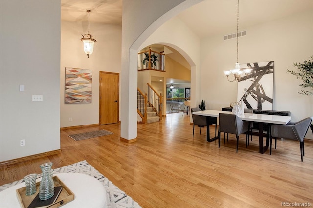 14910 Williams St, Thornton, CO 80602 - foyer entrance featuring stairs, a chandelier, light wood finished floors, baseboards, and arched walkways