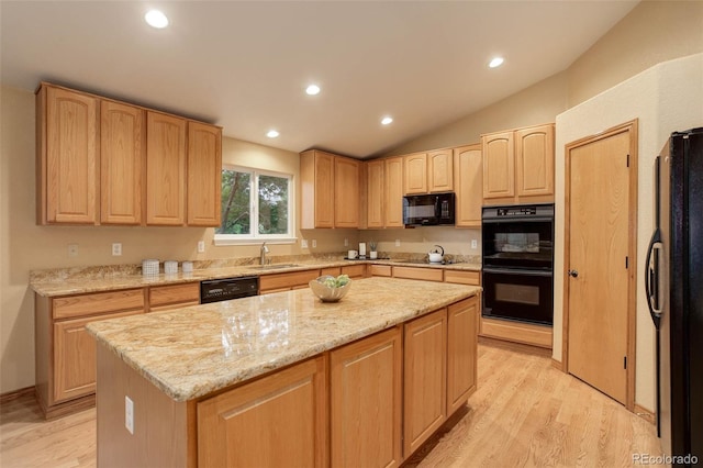 14910 Williams St, Thornton, CO 80602 - kitchen with light brown cabinetry, black appliances, a sink, light wood-type flooring, and lofted ceiling