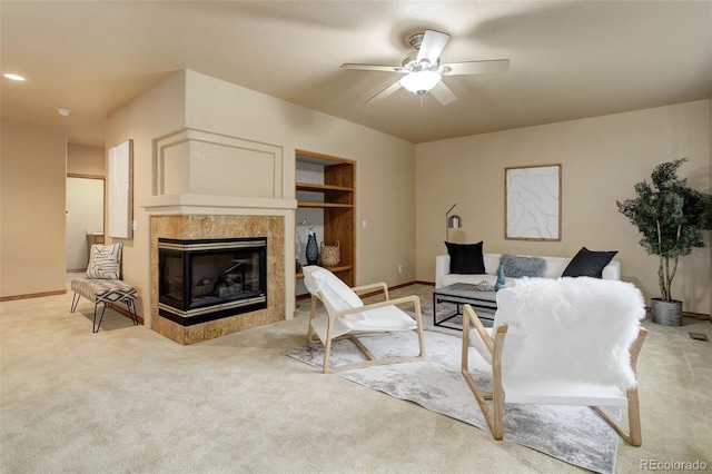 14910 Williams St, Thornton, CO 80602 - living area with light carpet, a ceiling fan, a tiled fireplace, and baseboards