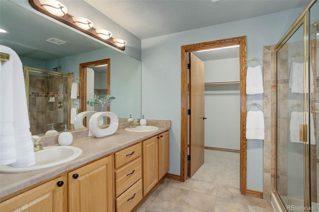 14910 Williams St, Thornton, CO 80602 - bathroom with a shower stall, double vanity, and a walk in closet