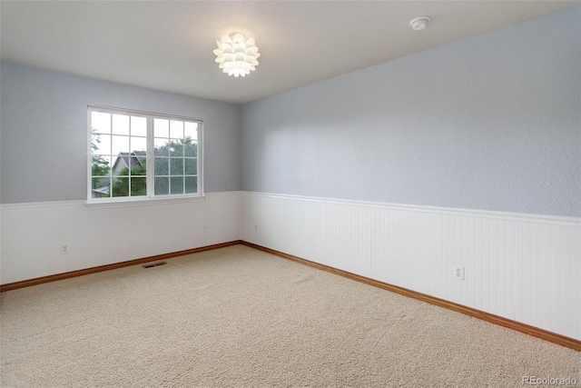 14910 Williams St, Thornton, CO 80602 - empty room featuring a smoke detector, wainscoting, and carpet flooring