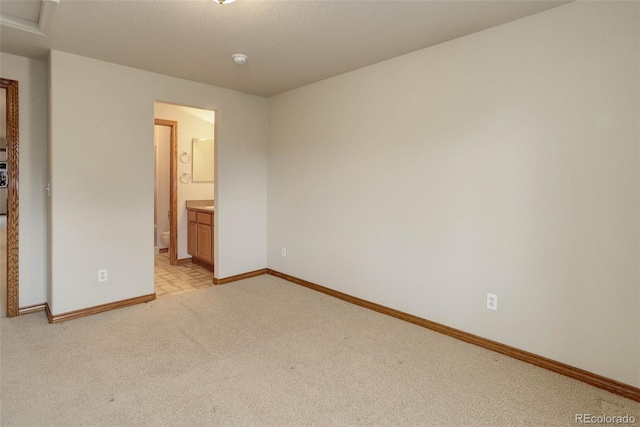 14910 Williams St, Thornton, CO 80602 - unfurnished bedroom featuring baseboards, light carpet, and ensuite bath