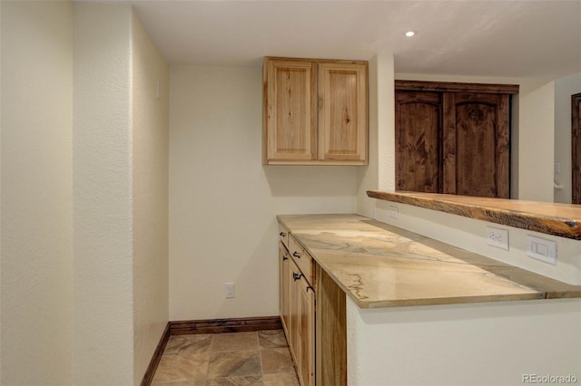14910 Williams St, Thornton, CO 80602 - kitchen with baseboards, light brown cabinets, light countertops, recessed lighting, and stone finish flooring