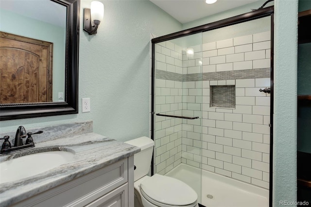 14910 Williams St, Thornton, CO 80602 - bathroom with toilet, a stall shower, vanity, and a textured wall