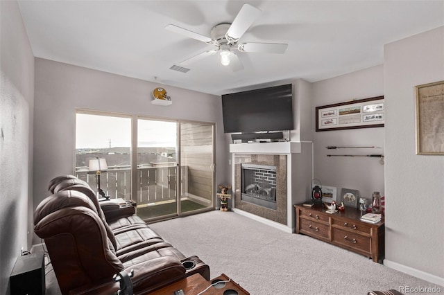 living area featuring carpet, visible vents, a fireplace, and a ceiling fan