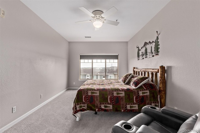 carpeted bedroom with baseboards, a ceiling fan, and visible vents