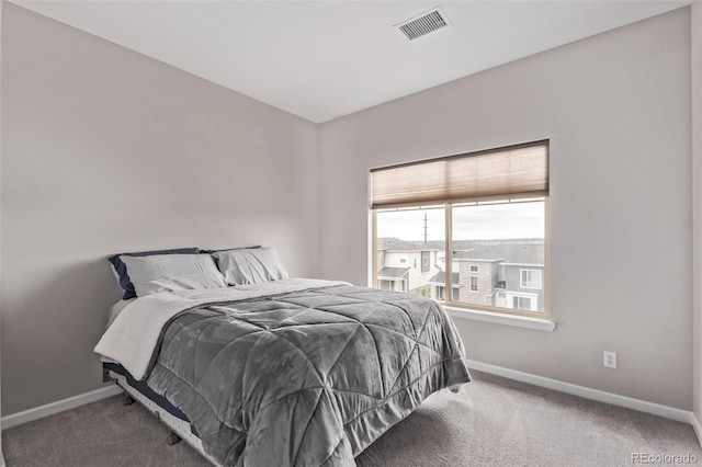 bedroom featuring carpet flooring, visible vents, and baseboards