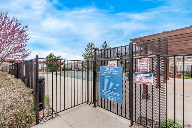view of gate with fence