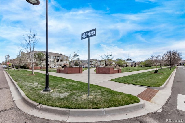 view of home's community with a lawn, a gazebo, and a residential view