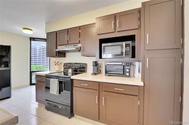 kitchen featuring light tile patterned flooring and black appliances