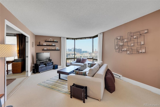 living room featuring a textured ceiling, baseboard heating, and carpet floors