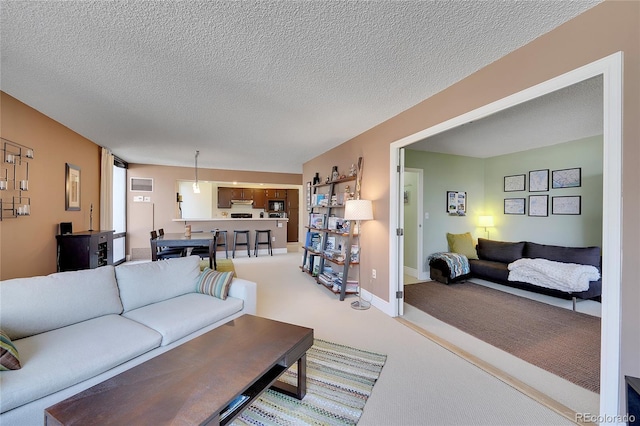 living room with a textured ceiling and carpet flooring