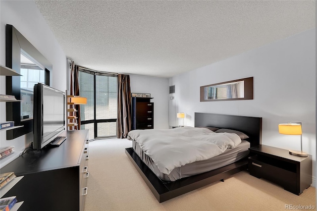 carpeted bedroom featuring a textured ceiling