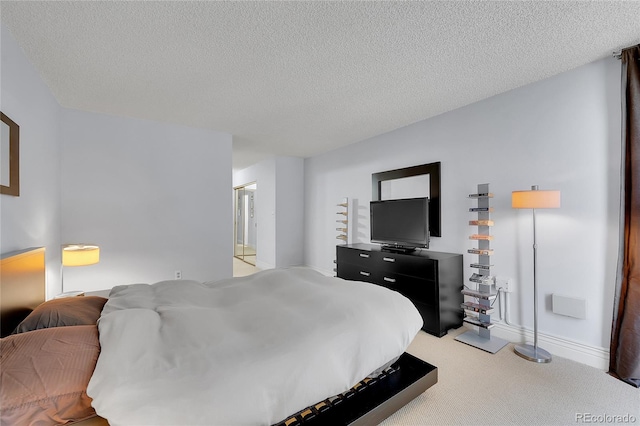 bedroom featuring a textured ceiling and carpet floors