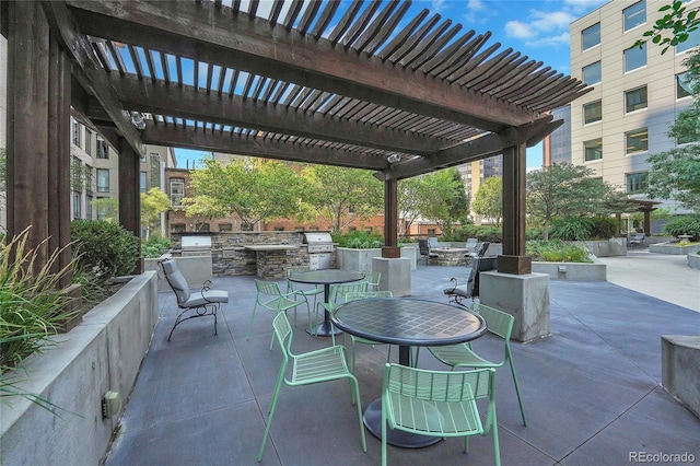 view of patio / terrace with an outdoor kitchen and a pergola