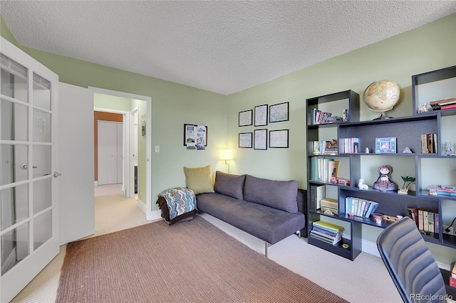 living room with a textured ceiling and carpet