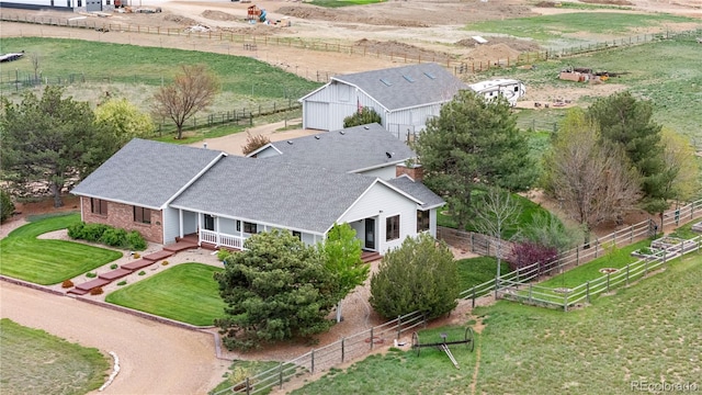 birds eye view of property with a rural view