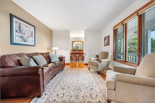 living room featuring wood finished floors and a chandelier
