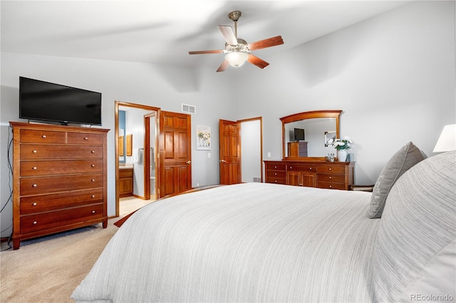 bedroom with visible vents, ensuite bathroom, high vaulted ceiling, light colored carpet, and a ceiling fan