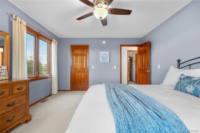 bedroom with light colored carpet, baseboards, ceiling fan, and visible vents