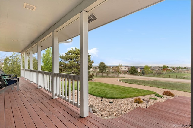 wooden deck featuring visible vents and a yard
