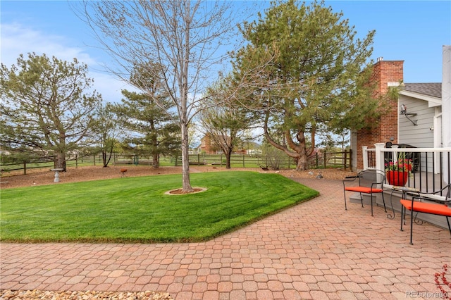 view of yard with fence and a patio