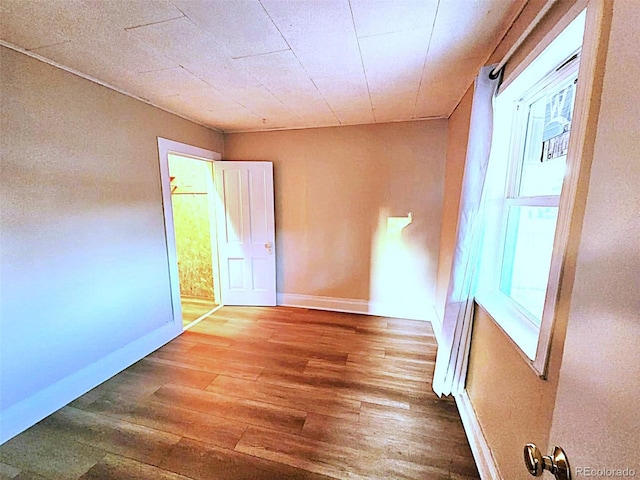 402 E 5th St, Julesburg, CO 80737 - empty room featuring hardwood / wood-style flooring and baseboards